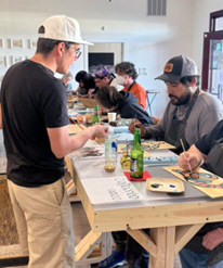 Bill teaches a group of students in a Tlingit formline workshop.