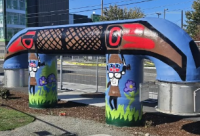 Tommy Segundo's mural Portage Ways, depicting Native peoples carrying a canoe from the Salish Sea to a freshwater lake.