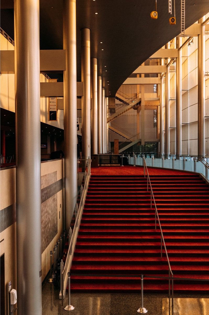 McCawHall.Staircase Futuristic silver pillars frame an impressive red staircase in McCaw Hall's lobby.